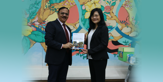 Dr. Prasun K Das APRACA Secretary General handing over a report on global landscape of green finance to Ms. Maria Theresa Medialdia Mekong Institute Director.